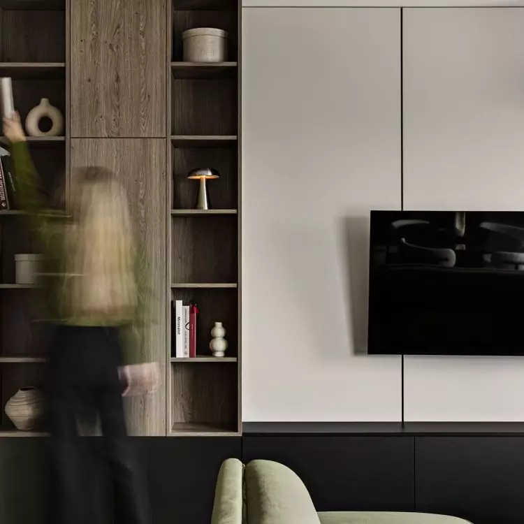 The living room furniture features a combination of open shelves, cabinets, and a space for the TV