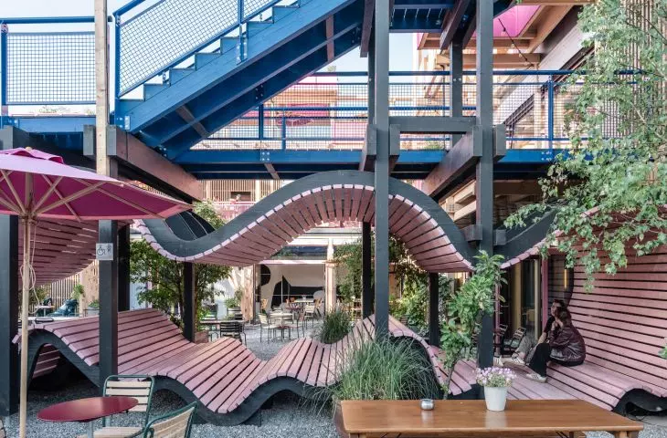 The undulating seats under the stairs create cozy spots to relax