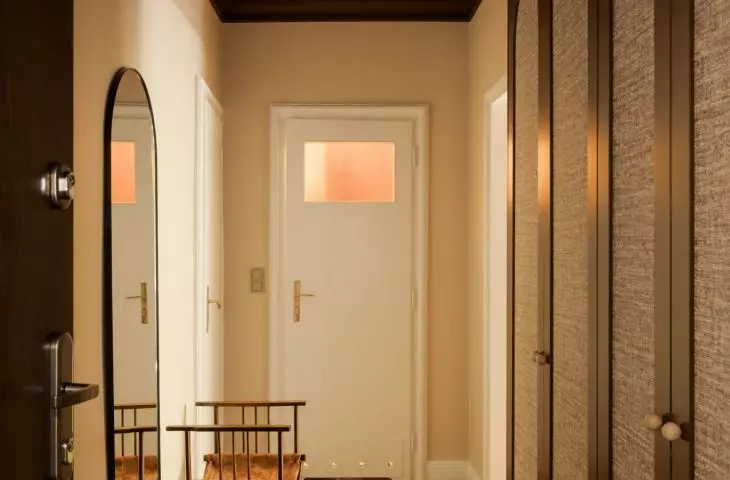 The dark ceiling draws the eye down the hallway, and the spacious closet keeps the entryway organized