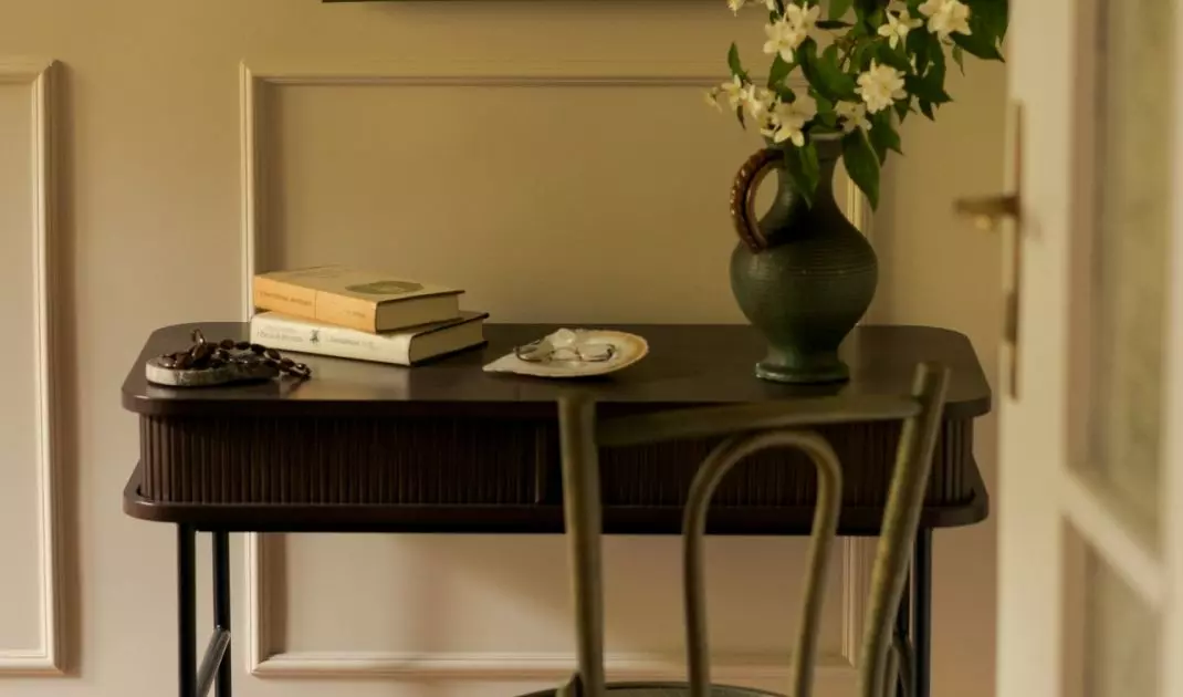 The small desk creates a space for studying, and the painting created by the resident gives it a personal touch