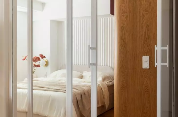 Sliding glass doors separate the bedroom without blocking the light