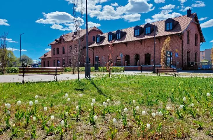 The Pleszew Miasto train station, converted into the Municipal Library; view from the square on Ogrodowa Street, next to the P+R parking lot