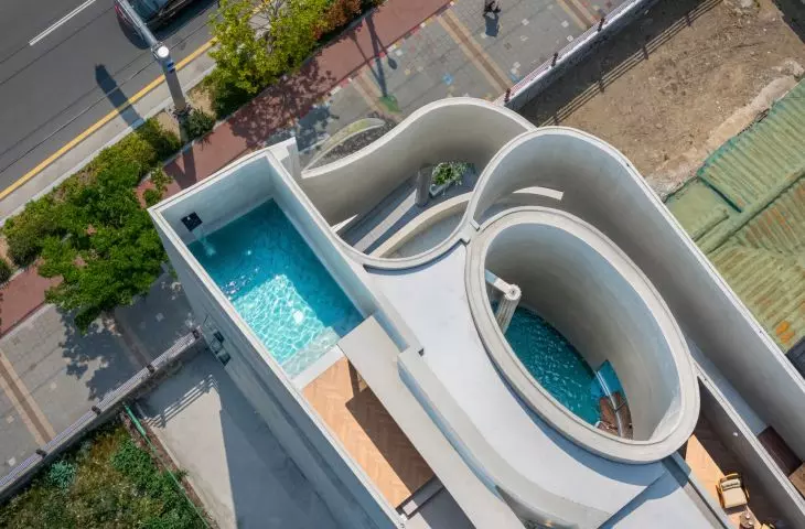 The oval pool opens directly onto the sky