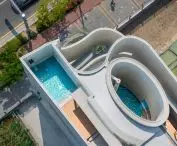 The oval pool opens directly onto the sky