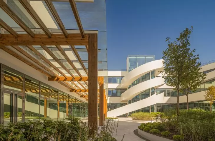A partially covered walkway leads through the green courtyard