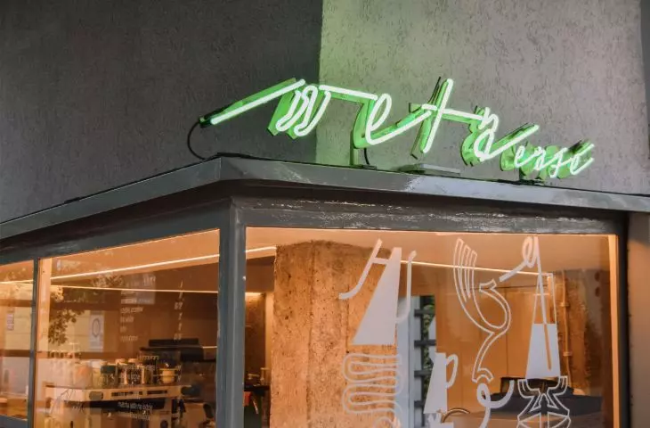 the café's green neon sign