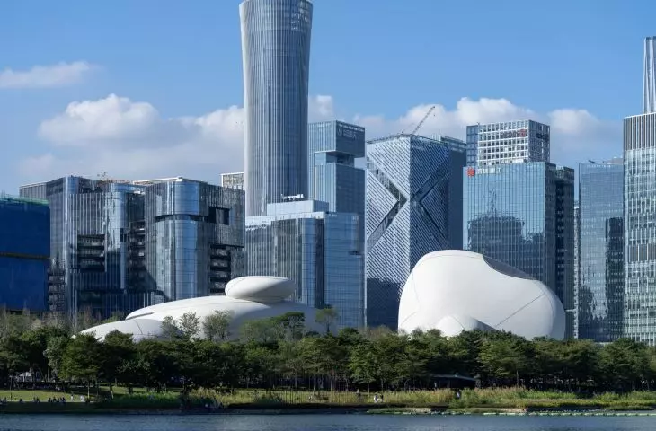 The museum's low-rise structures stand out clearly against the skyline of skyscrapers in the Houhai district