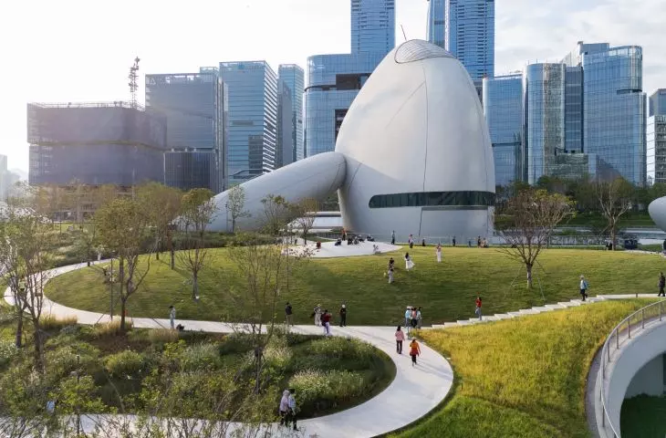 The park surrounds the rounded pavilions and allows visitors to walk freely through the complex