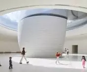 The curved walls and the light streaming in from above define the interior of one of the atria