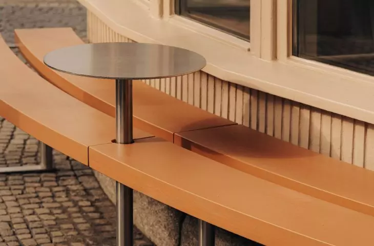 outdoor bench with a round table
