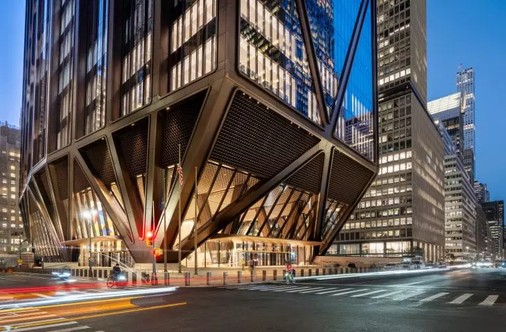 After dark, the glass-enclosed ground floor reveals a fan-shaped arrangement of steel supports