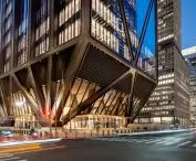 After dark, the glass-enclosed ground floor reveals a fan-shaped arrangement of steel supports