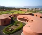 The residential area consists of low, rounded buildings clustered around small gardens