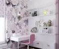 Floral wallpaper on the wall by the desk and bed