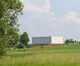 The minimalist body of the concert hall is elevated above the first floor of the center