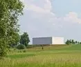 The minimalist body of the concert hall is elevated above the first floor of the center