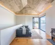 Large windows offer a view of the mountainous surroundings