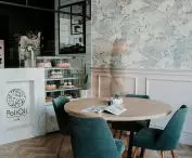 Green armchair upholstery coordinates with pink design elements