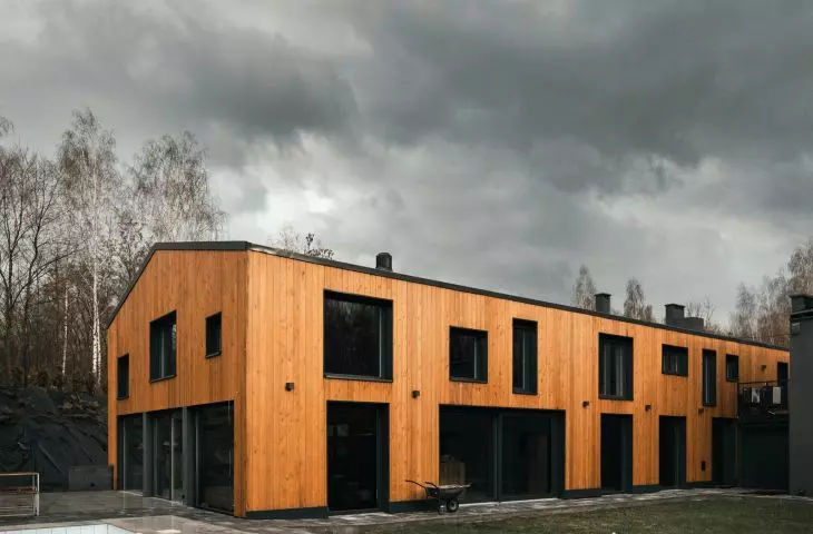 The wooden façade of the Slezna Chałpa is pierced with large, irregular openings