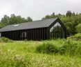 monochromatic body of the building houses the living area, guest rooms and the artist's studio