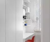 Red chair breaks the white of the room