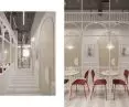 Red chairs break up the brightness of the room