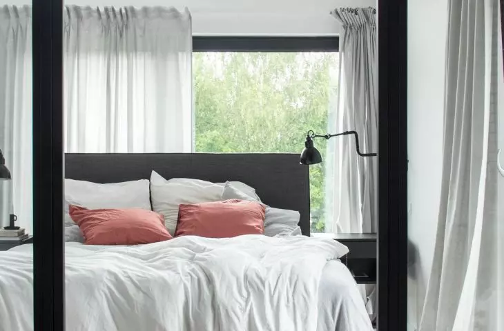 Glass walls between bedroom and bathroom
