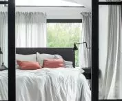 Glass walls between bedroom and bathroom