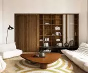 Behind the door in the living room is the bedroom
