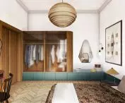 Wooden panel on the wall goes into the closet 