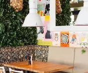Green wall at the junction with a wall covered with collages