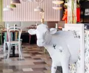 The front of the cow coming out of the picture frame