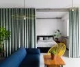 A mint-colored curtain separates the spaces
