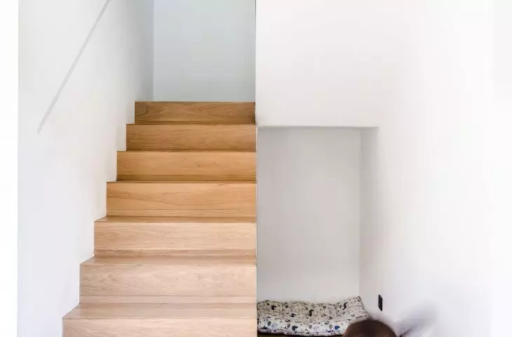 A wooden staircase leads to the first floor