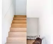 A wooden staircase leads to the first floor