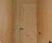 inside, upstairs and attic, dominated by light spruce plywood
