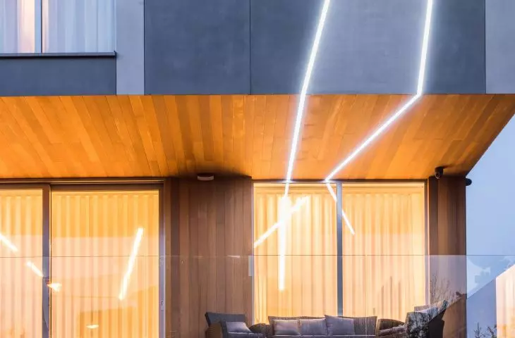 The facade is punctuated by illuminated lines