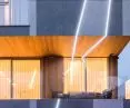 The facade is punctuated by illuminated lines
