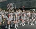 Girl Scouts walk in a parade on Marszalkowska Street. In the background, decorations on the 