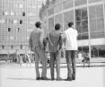 Men looking at the PKO Rotunda. Visible scaffolding inside the building. The 