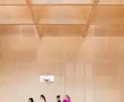 the sports hall is covered with a grid of glulam beams