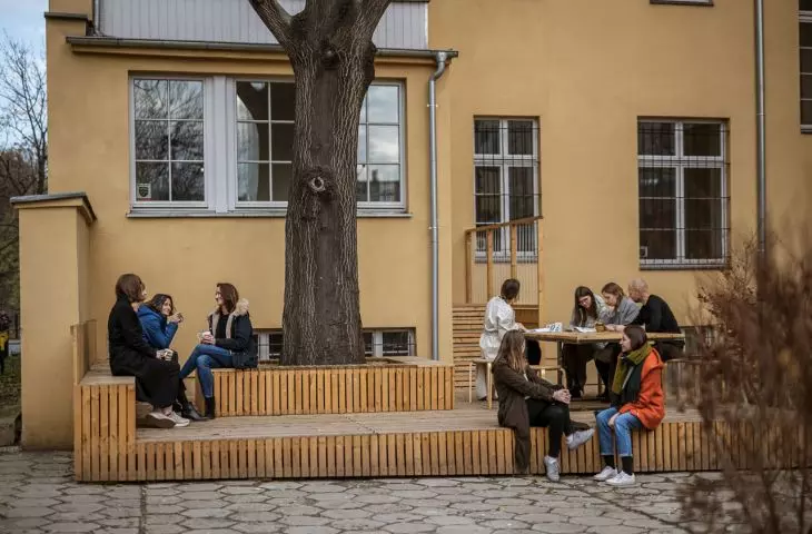 wooden terrace in Wroclaw's courtyard is an open meeting place for residents of the townhouse