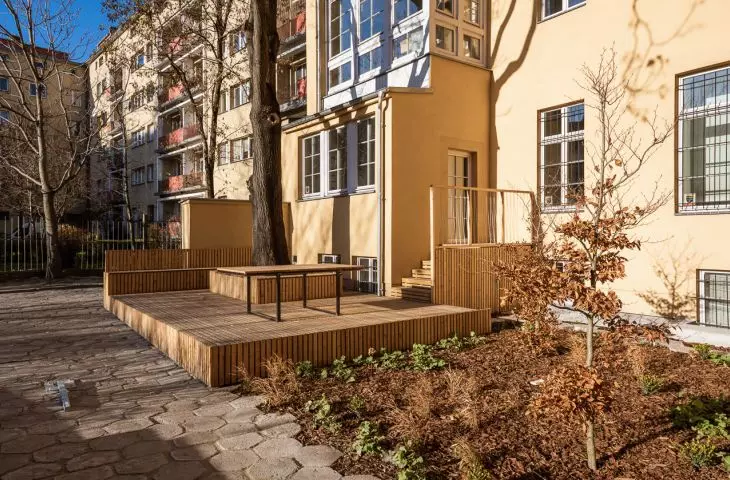 greenery was planted next to the wooden terrace