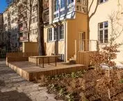 greenery was planted next to the wooden terrace