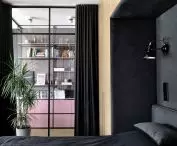 The bedroom can be visually separated from the rest of the apartment by a heavy black curtain