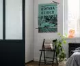 The bedroom is separated from the living room by glass walls