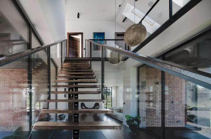 A wooden staircase leads to the first floor