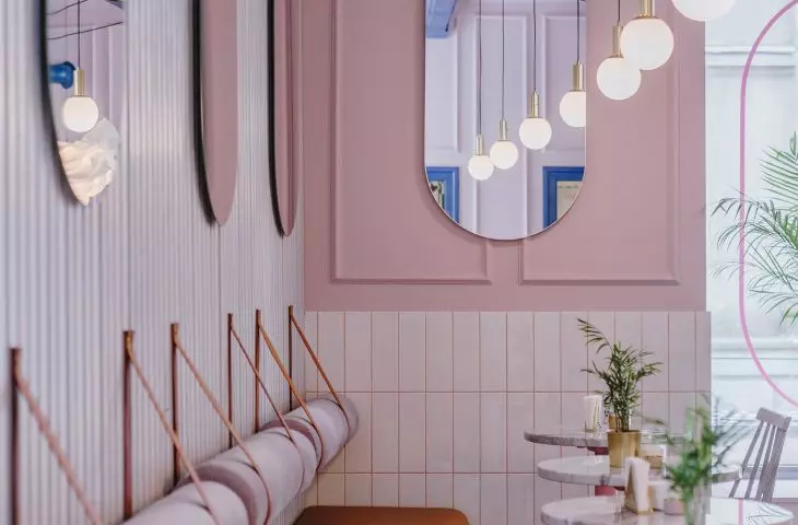 oval mirrors optically enlarge the cafe space