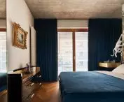 The black bed was upholstered with the same material used for the bedroom curtains and trimmed with a burgundy silk roller