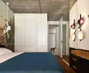 a set with the bed is a black dresser with gold accessories